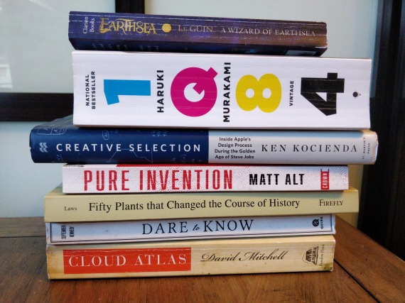 A stack of books including many mentioned in this post like IQ84 and Pure Invention